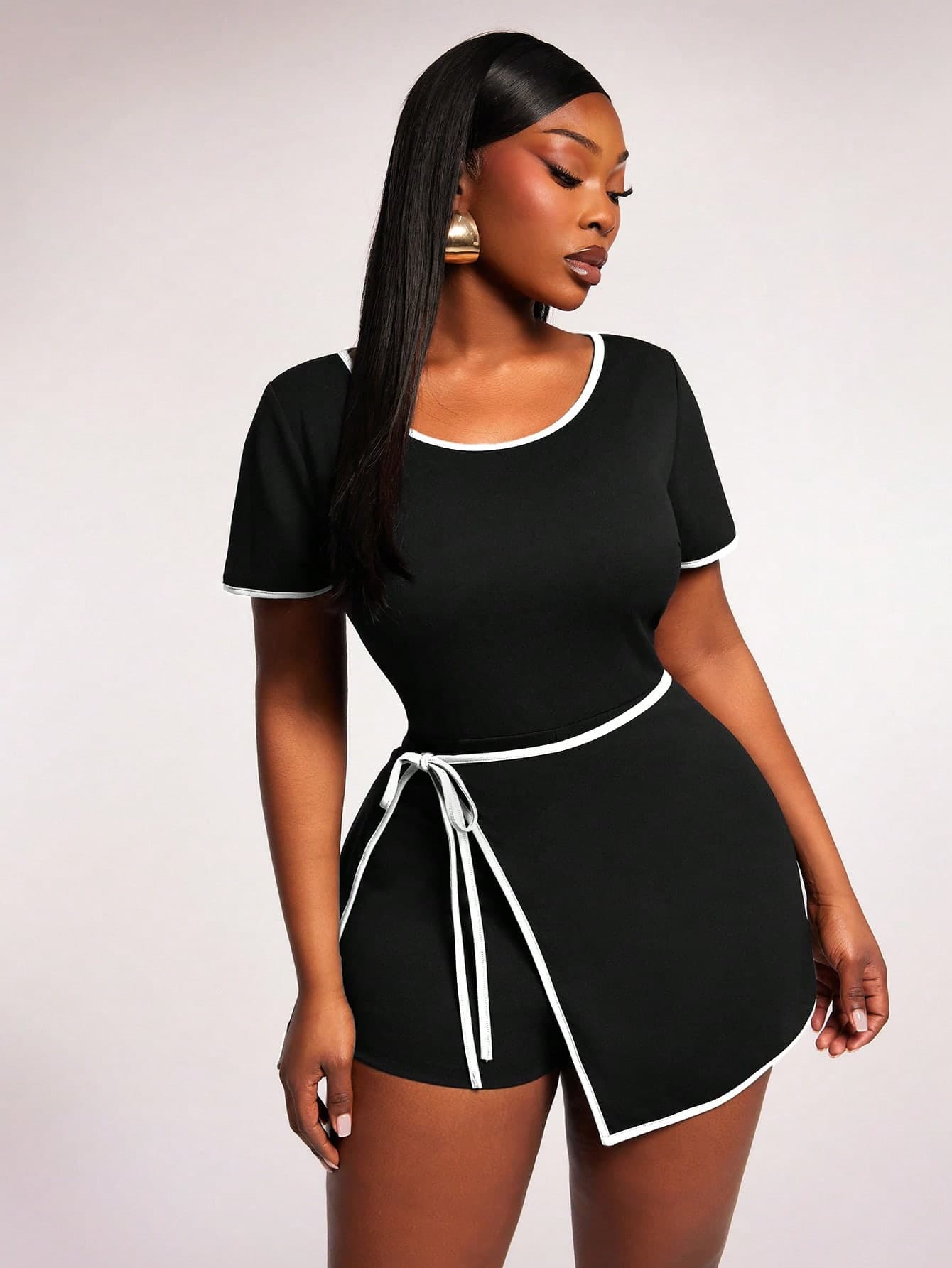 Radiana Black Short Sleeve Sports Jumpsuit For Women Featuring White Contrast Piping And Tied Waist